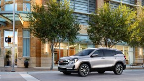 A silver 2021 GMC Terrain SLT crossover SUV on a city street