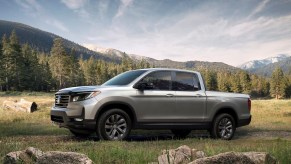 A silver 2021 Honda Ridgeline parked on a grassy hill