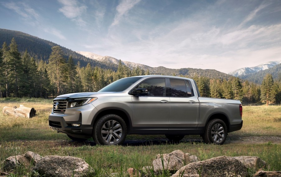 A silver 2021 Honda Ridgeline parked on a grassy hill