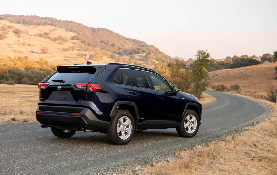 A 2021 Toyota RAV4 XLE Hybrid compact crossover SUV with Blueprint exterior paint parked on a rural road