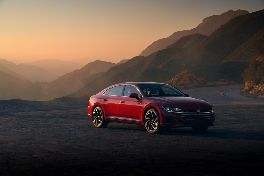 A red 2021 Volkswagen Arteon parked at a mountain overlook