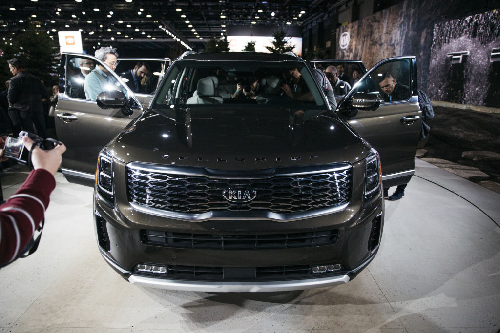 The front end of a dark colored kia telluride