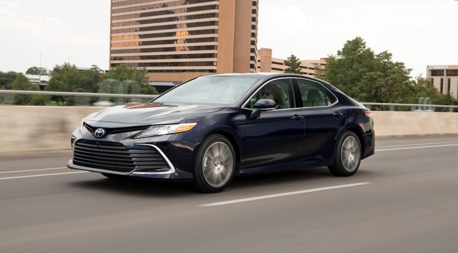 A blue Toyota Camry XLE Blueprint driving on the highway