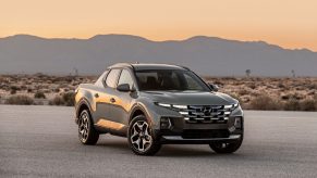 A silver 2022 Hyundai Santa Cruz parked in the desert while the sun sets