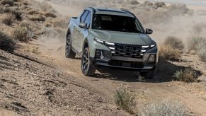 The 2022 Hyundai Santa Cruz driving on a dirt road