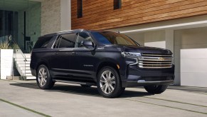 The 2023 Chevy Suburban full-size SUV parked in front of a home in a driveway.