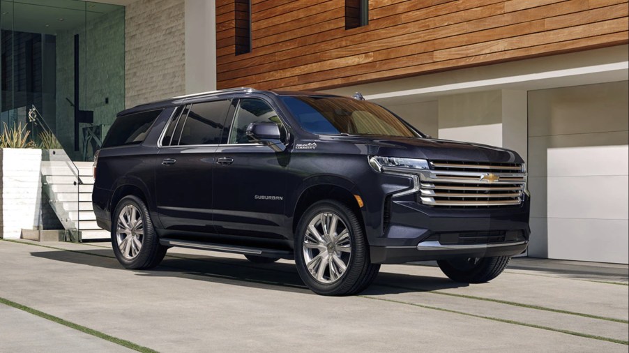 The 2023 Chevy Suburban full-size SUV parked in front of a home in a driveway.