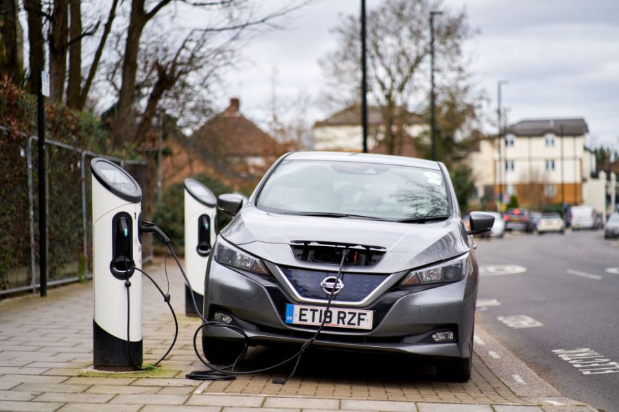 A gray nissan leaf on the charger