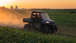 a Polaris Ranger driving between to corn fields is a side-by-side from the most popular ATV and UTV brand