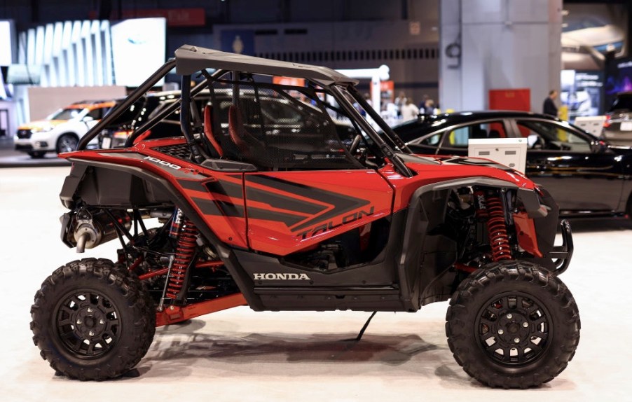 a red Honda Talon UTV on display at an indoor auto show