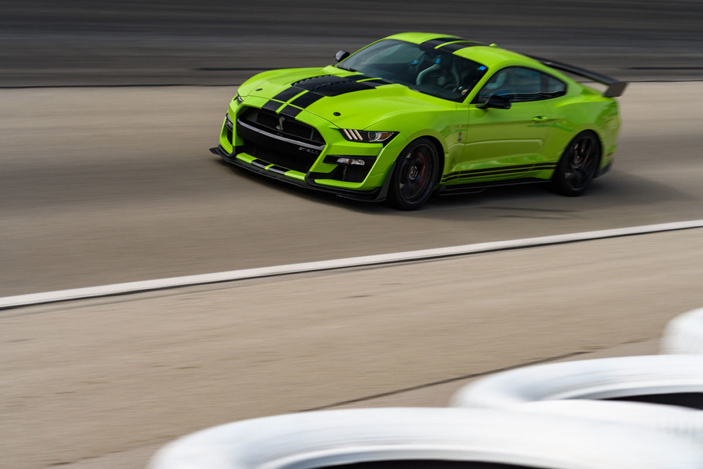 a bright green 2021 Shelby gt500 mustang taking a lap on the Texas motor speedway track