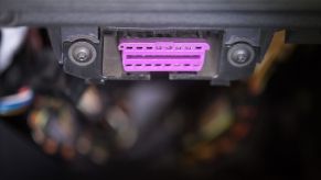 A car's pink-purple OBD-II port