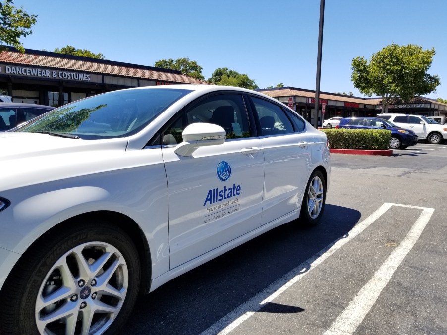 An blue Allstate insurance logo on a white sedan in Dublin, California, on a sunny day in July 2018