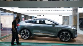 A gray Audi Q4 e-tron electric car stands on display at a press preview at the Greentech Festival