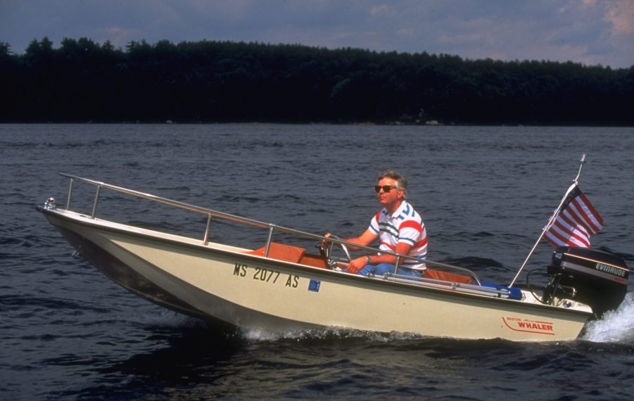 Test engineer William MacDonald, in sunglasses, taking his new Boston Whaler motor boat for a spin