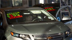 A shopper looks at a silver Chevy car for lease at Stewart Chevrolet Cadillac in Colma, California, on Wednesday, January 30, 2013