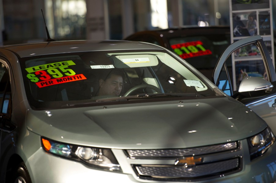 A shopper looks at a silver Chevy car for lease at Stewart Chevrolet Cadillac in Colma, California, on Wednesday, January 30, 2013