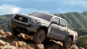 2021 Toyota Tacoma climbing rocks in remote and mountainous terrain.