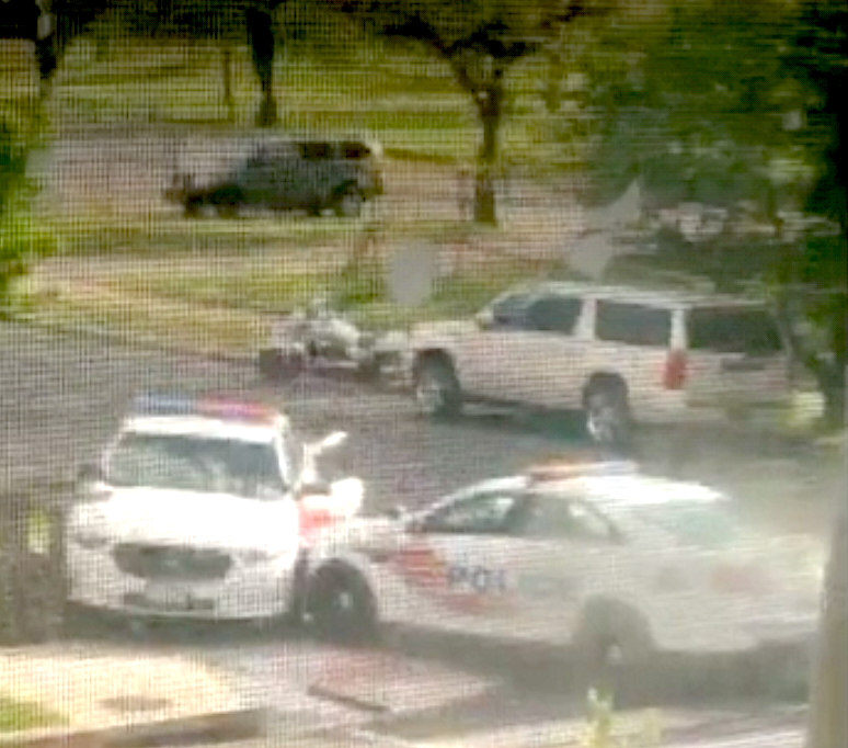 looking through a screen door of police drag racing each other