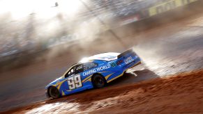 Daniel Suarez slides the blue #99 Chevrolet at the 2021 NASCAR Cup Series Food City Dirt Race at Bristol