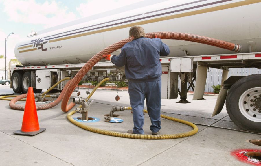 A tanker truck delivers gasoline to a gas station | Tim Boyle/Getty Images