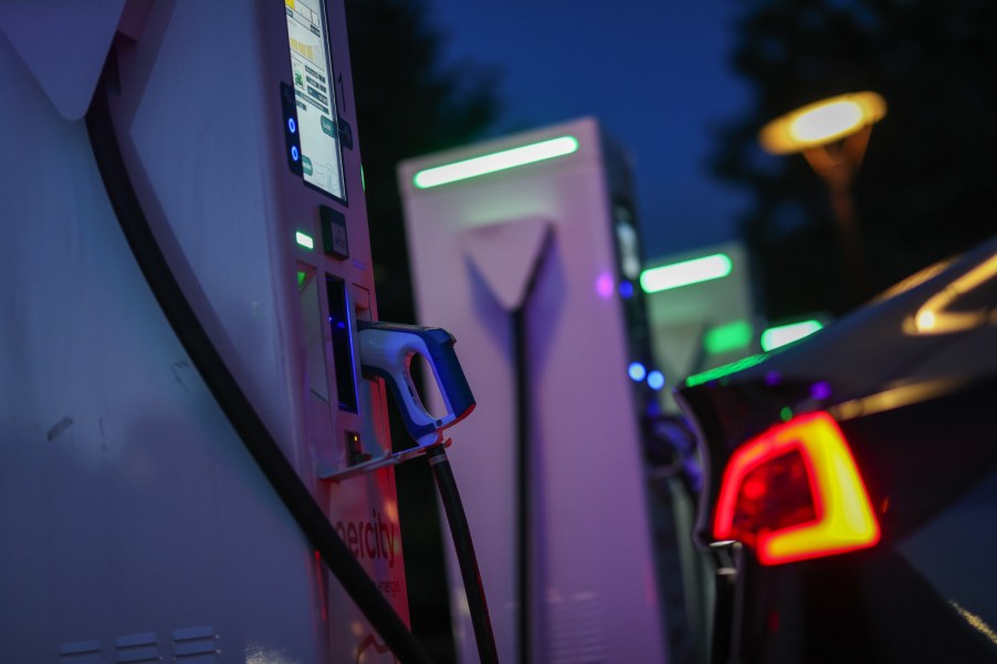 An electric vehicle charging station lights up at night