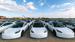 An image of several Tesla Model 3's parked outside.