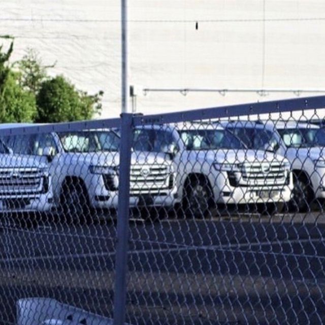 An image of a Toyota Land Cruiser pictured outside of a factory.