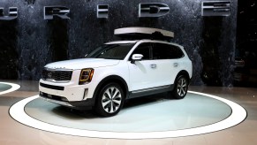 A white Kia Telluride sits on display at an auto show