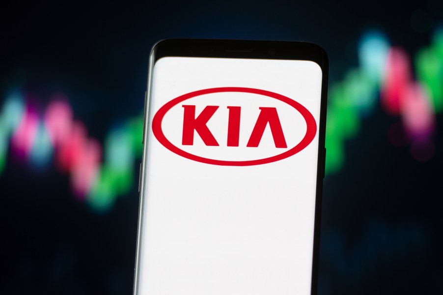 The Kia logo displayed against neon lights