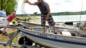 A man works on launching his boat.