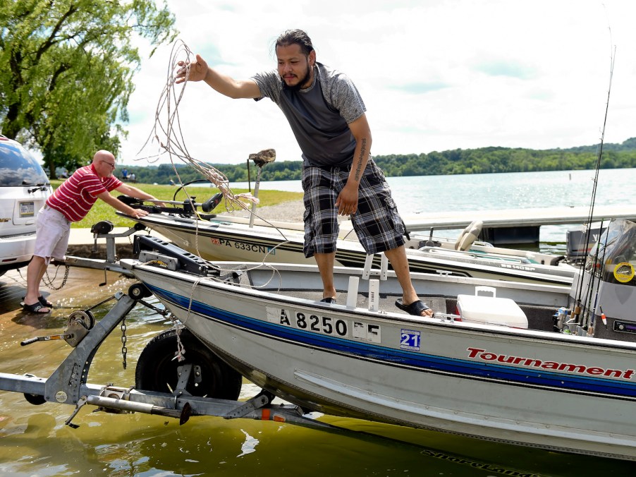 A man works on launching his boat.