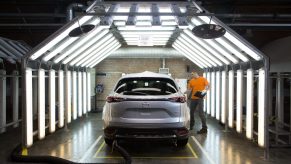 A worker inspects a Mazda Motor Corp. CX-9 sports utility vehicle (SUV) in a light tunnel at the Mazda Sollers Manufacturing Rus LLC plant