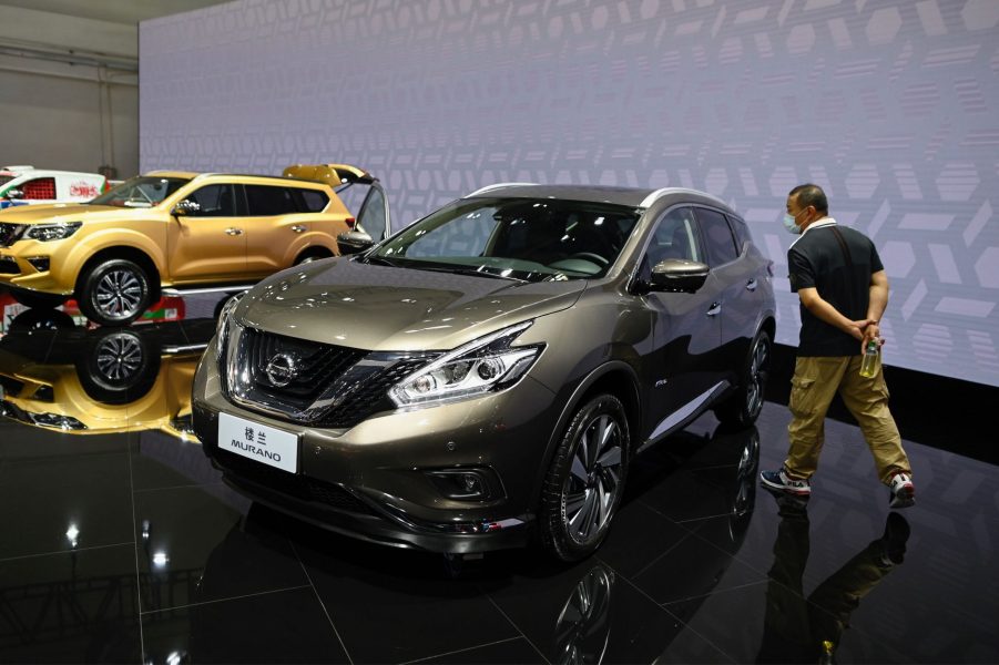 A man looks at a Nissan Murano car displayed at the Beijing Auto Show in Beijing