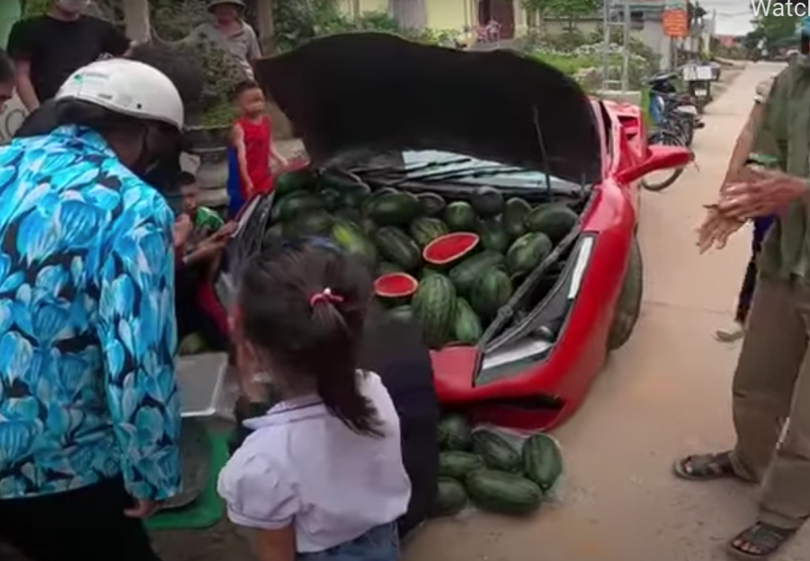 Phony Ferrari trunk open with melons for sale