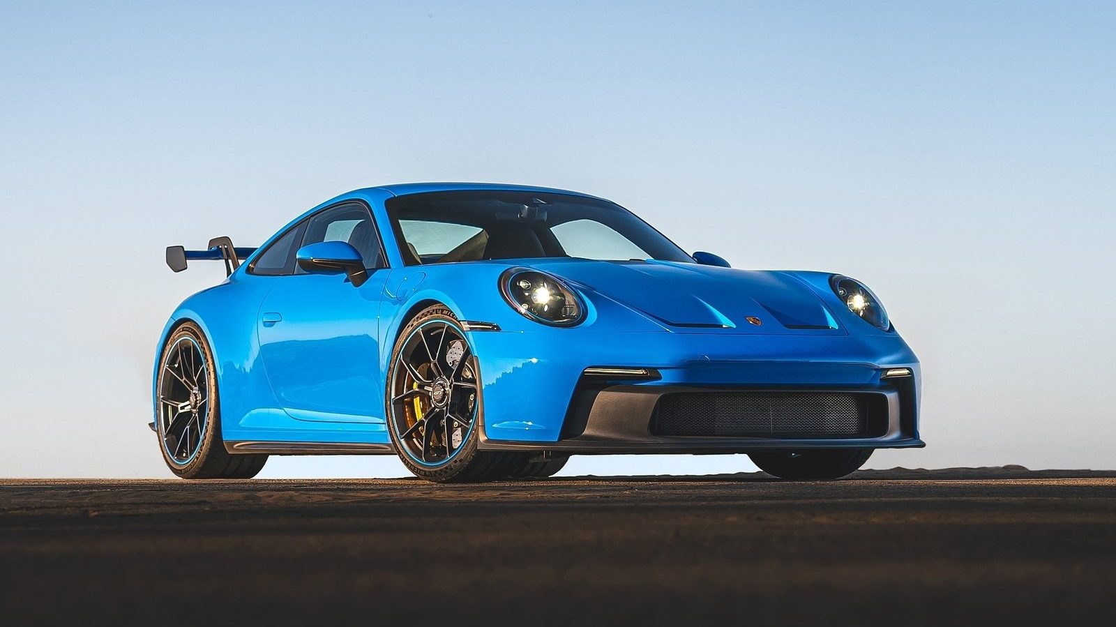 An image of a blue 2022 Porsche 911 GT3 on a track.