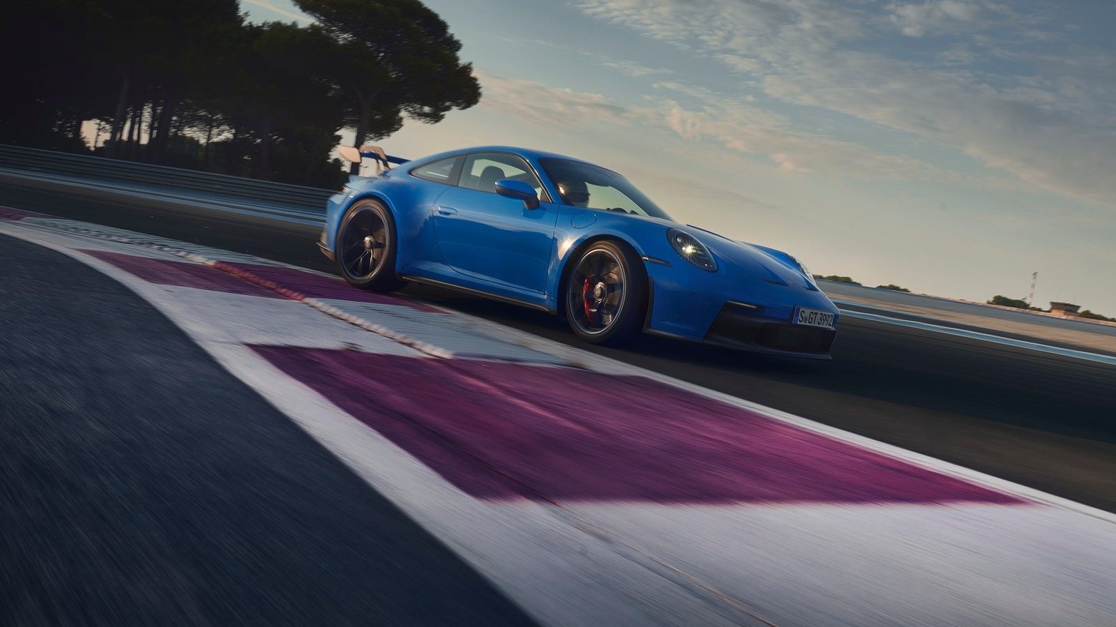 An image of a blue 2022 Porsche 911 GT3 on a track.