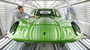 A bright green Porsche Macan on the assembly line