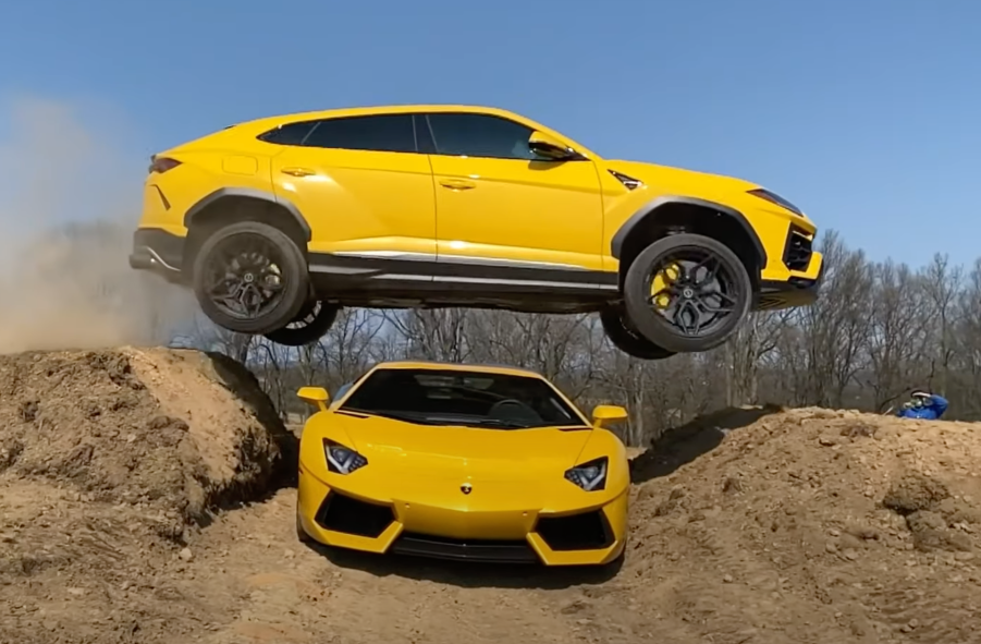 An image of a yellow Lamborghini Urus jumping over an Aventador.