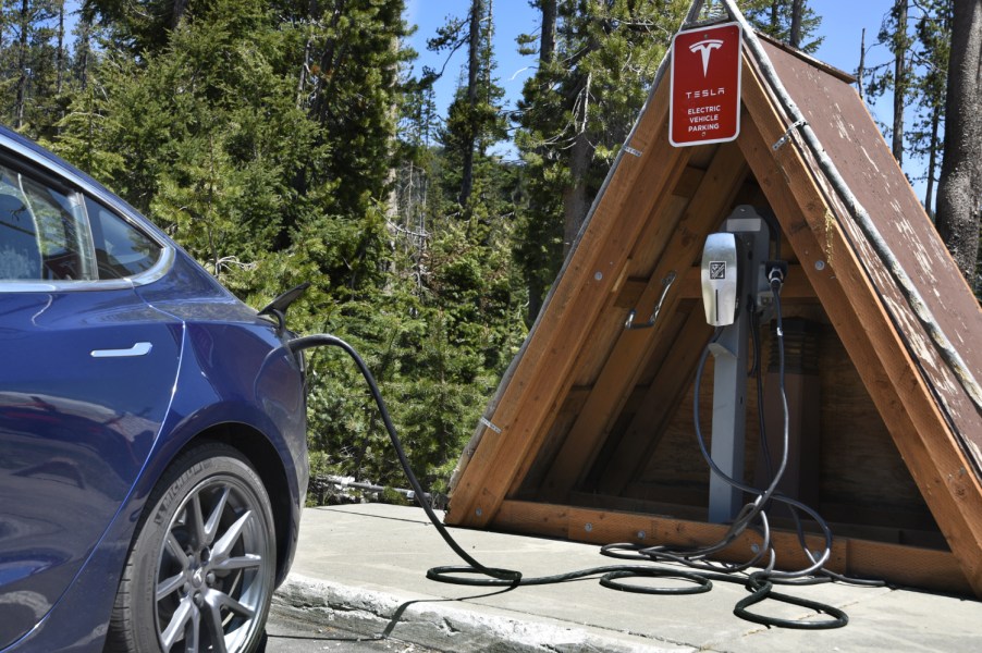 A Tesla electric vehicle plugged in for a charge