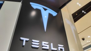 A Tesla sign lit up at a store