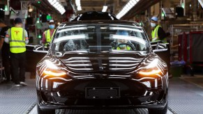 A Tesla Model 3 sits on the assembly line