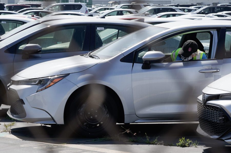 A worker parks a silver Toyota Motor Corp. Corolla vehicle at a Toyota Logistics Services Inc. automotive processing terminal at the Port of Los Angeles