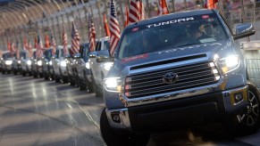 A lineup of Toyota Tundra pickup trucks driving a few miles around a track.