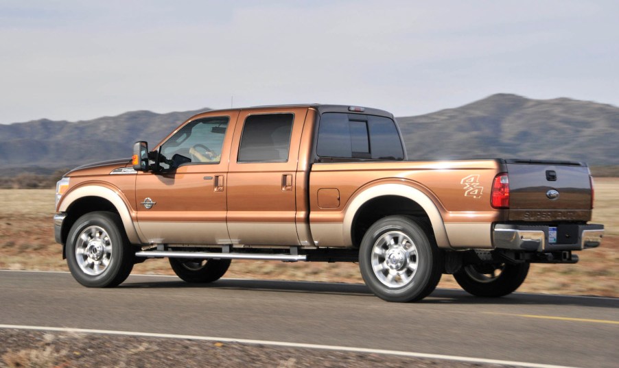 A 2011 Ford F250 diesel pickup truck being driven by a mountain range.