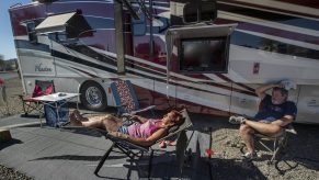 Janna Wilson, 64, and her husband John, 66, sunbathe next to their 40 foot long motorhome located at Quail Run RV Park in Quartzsite, Arizona. They have been full time RVers since June of 2020.