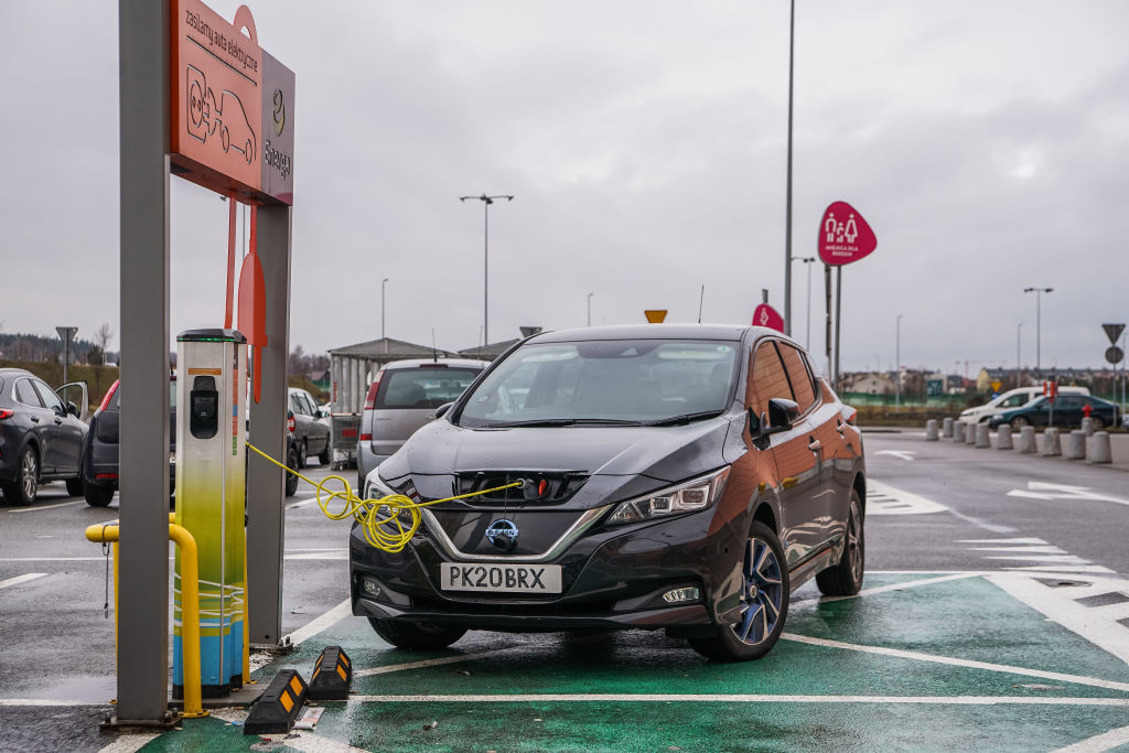 A black nissan leaf on the charger