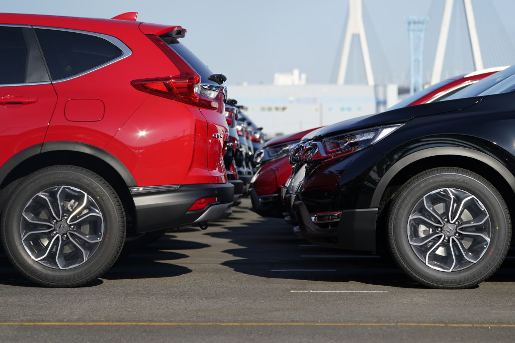 A lineup of honda vehicles in a full parking lot