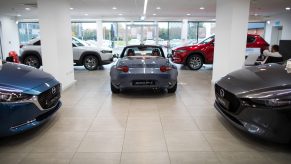 The rear end of a mazda mx5 miata in a mazda showroom