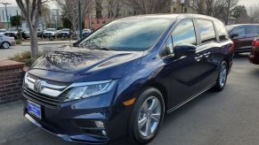 The front end of a dark blue honda odyssey mini van